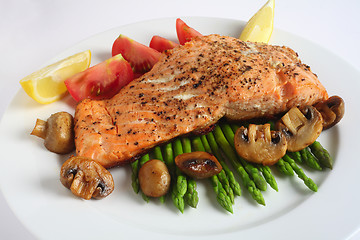 Image showing Salmon steak dinner with mushroom, asparagus, tomatoes