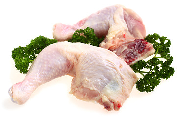 Image showing Fresh chicken legs with parsley garnish