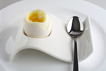 Image showing White egg on plate with spoon