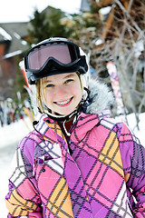 Image showing Happy girl in ski helmet at winter resort