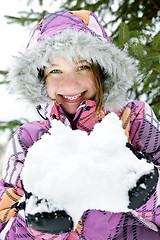 Image showing Happy winter girl holding snow