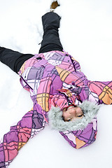 Image showing Girl making snow angel