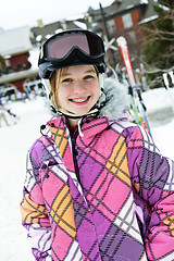 Image showing Happy girl in ski helmet at winter resort