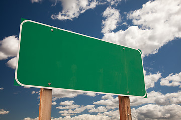 Image showing Blank Green Road Sign Over Clouds