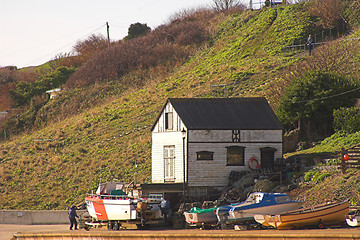 Image showing Old boathouse & boats