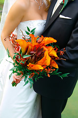 Image showing Colorful Bouquet Held by a Bride and Groom