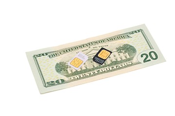 Image showing Two SIM cards for cellular phones on dollar bill isolated 