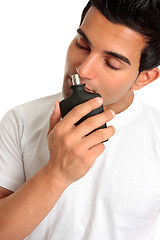 Image showing Man smelling aftershave cologne