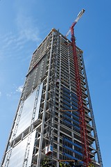 Image showing Lifting crane at skyscraper construction site