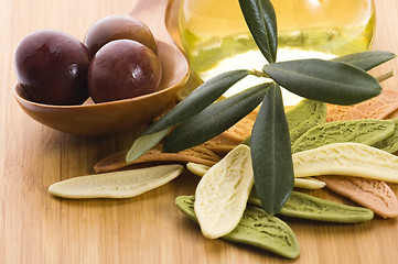 Image showing pasta, black olives, oil with fresh branch. food ingredients 