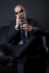 Image showing businessman smoking and drinking
