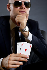 Image showing businessman holding a poker hand