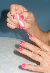 Image showing elderly painting the nail fingers