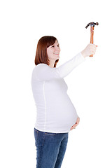 Image showing Pregnant Mother Pounding a Hammer