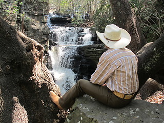 Image showing Cowboy by waterfall