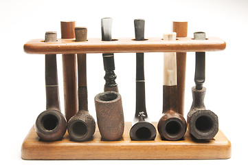 Image showing pipe collection in wood pipe rack