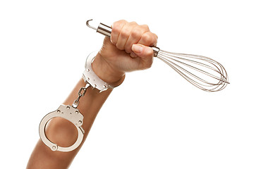 Image showing Handcuffed Woman Holding Egg Beater in Air on White