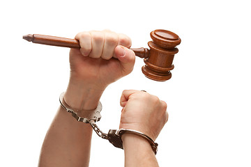 Image showing Handcuffed Man Holding Wooden Gavel on White