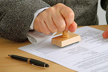 Image showing Stamping  a document
