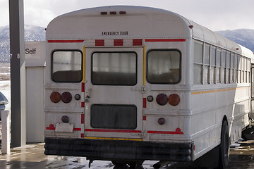 Image showing White School Bus Pumping Gas