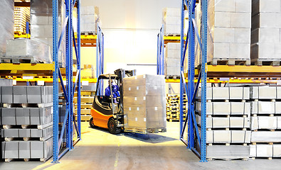 Image showing forklift loader and worker at warehouse