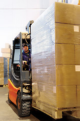 Image showing forklift worker in loader at warehouse