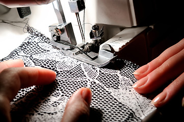 Image showing hand sewing on the machine