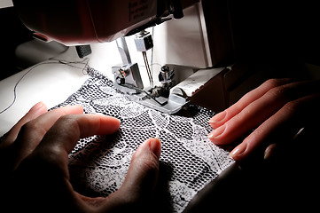 Image showing hand sewing on the machine