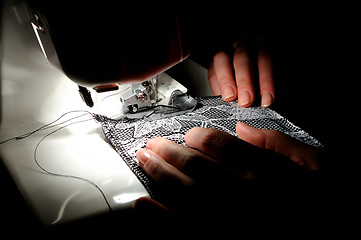 Image showing hand sewing on the machine