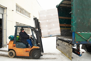 Image showing warehouse forklift loading a car