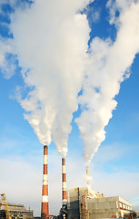 Image showing three smoking chimneys of power plant