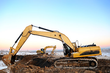 Image showing two loader excavators in open cast in winter