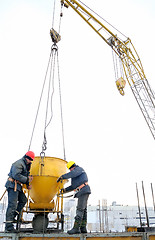 Image showing building workers pouring concrete in form