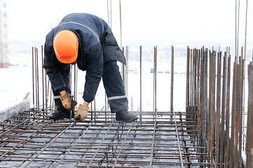 Image showing worker at construction site making carcass