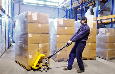 Image showing worker with stacker at warehouse