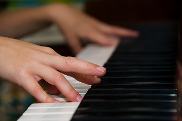 Image showing hands on keys of a piano