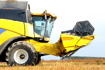 Image showing combine harvester during field work on farm