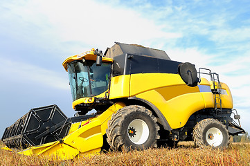 Image showing combine harvester during field work on farm