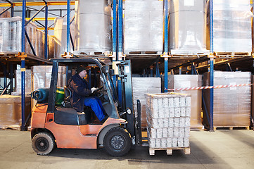 Image showing warehouse work with forklift loader