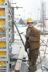 Image showing worker with hammer assembling formwork