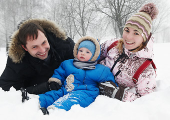 Image showing smiling family with child in winter