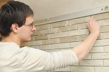 Image showing worker tiler at work