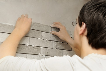 Image showing worker tiler at work