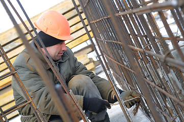 Image showing worker at construction site making carcass