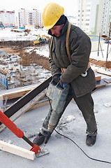 Image showing worker builder drill and concrete formwork