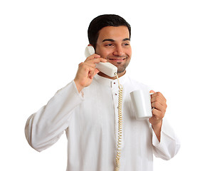 Image showing Traditional ethnic business man talking on telephone