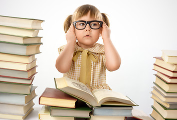 Image showing Little girl with books wearing black glasses