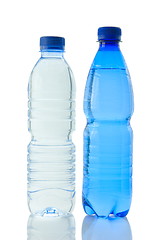 Image showing Bottles  of mineral water reflected on white background