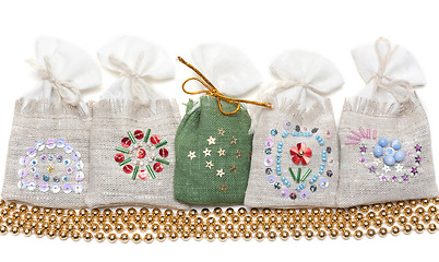 Image showing Bags with spice and golden necklace
