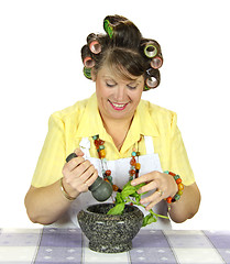 Image showing Housewife Crushing Herbs